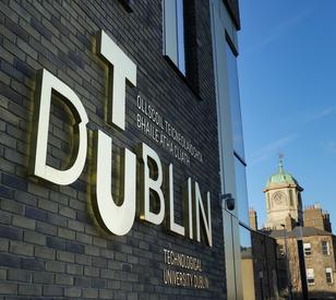 An image of the TU Dublin logo with the clock tower in grangegorman in the background