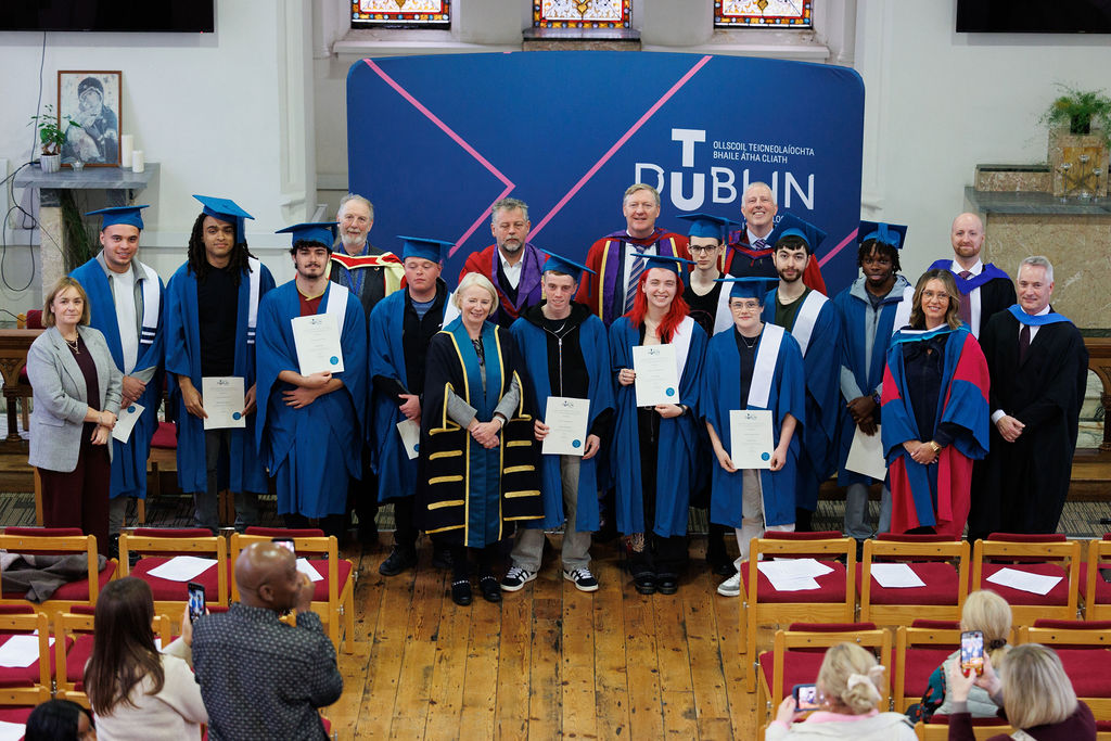 A group pose for a photo in front of  TU Dublin banner