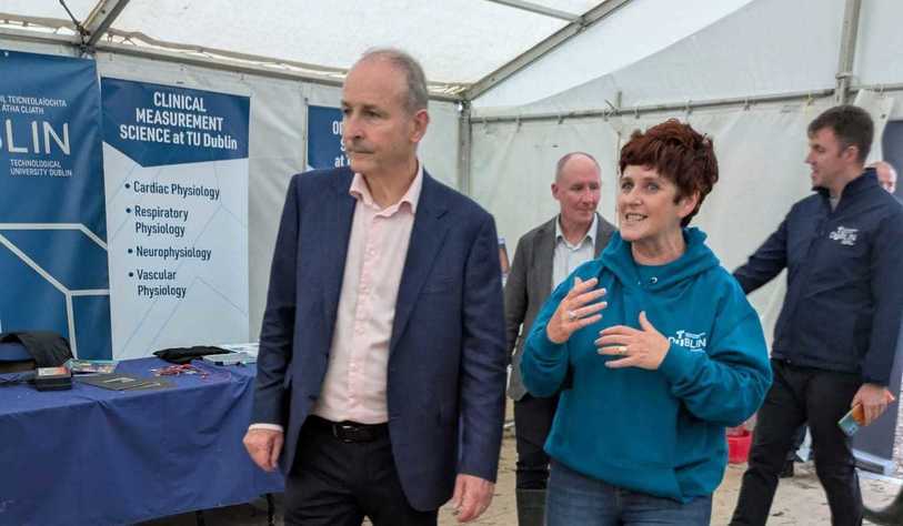 Two people talking in a tent