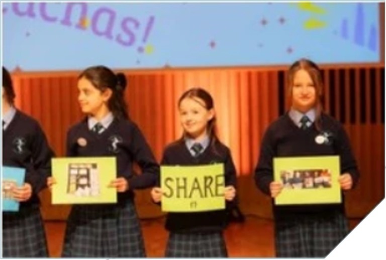 Pupils holding signs at school of sanctuary awards