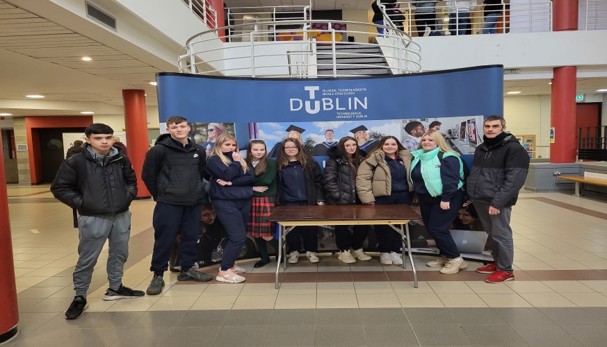 Group of TY students standing in front of TU Dublin Banner in entrance hall