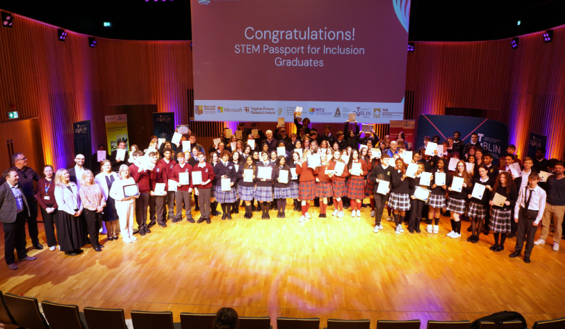 Group of TY students holding their certificates, celebrating their STEM Passport for Inclusion graduation in TU Dublin's Concert Hall