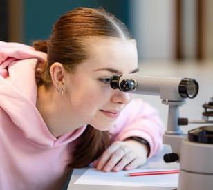 Looking into a microscope