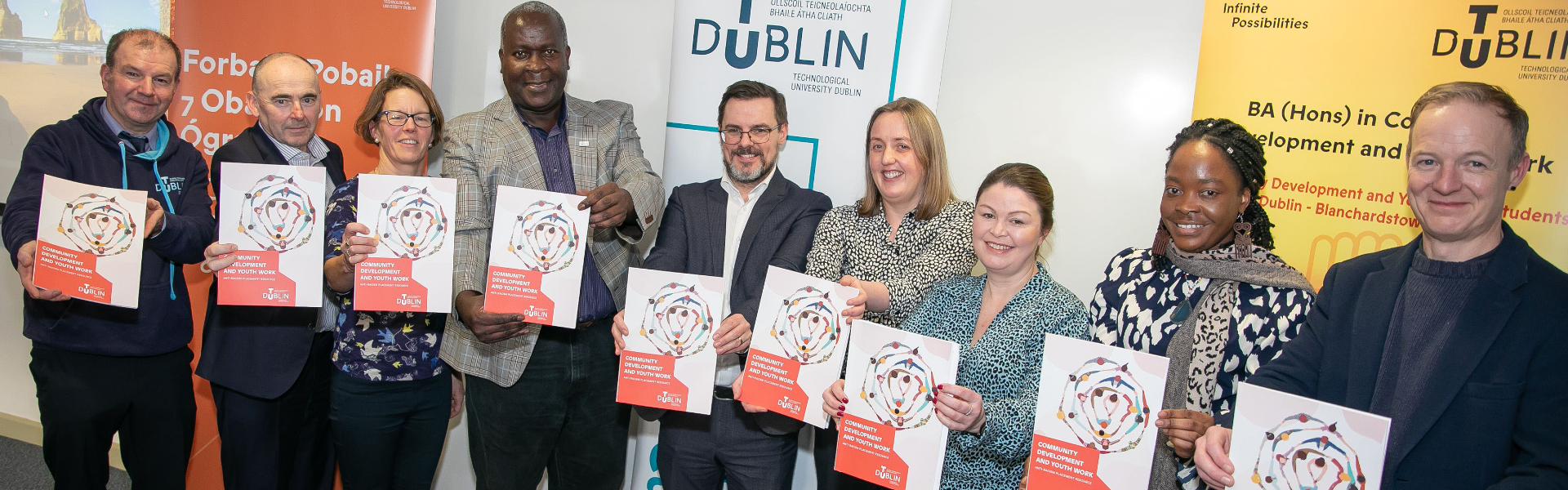 TU Dublin staff members in a line, each holding the Anti Racism Placement Resource document