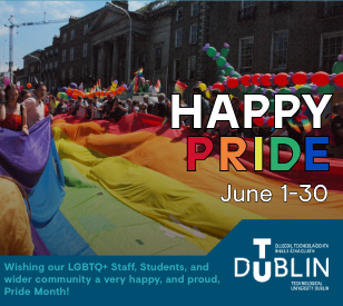 image of lgbtq+ pride march in dublin showing demonstrators holding a large pride flag. text overlain reads 