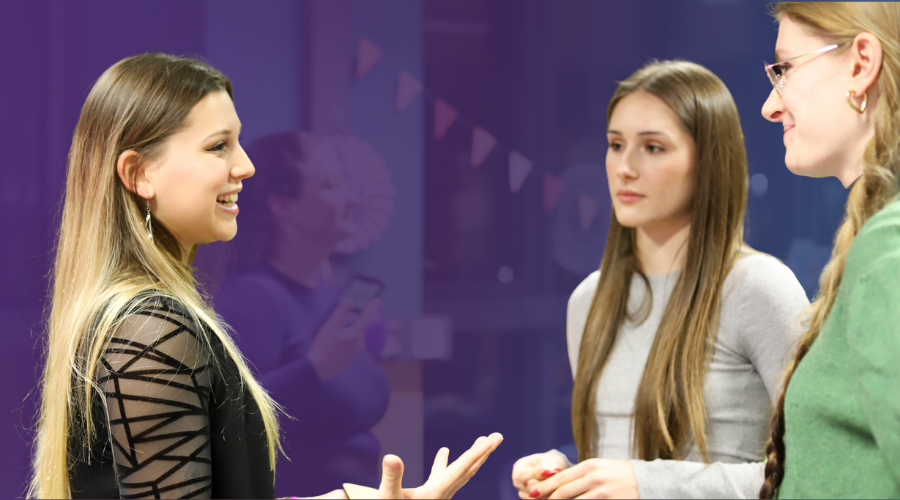 Three students having a conversation