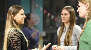 Three students having a conversation