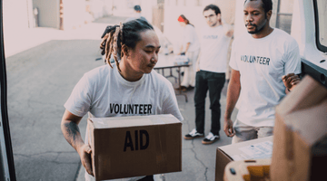 Image for Volunteer lifting boxes from van