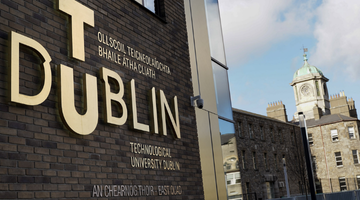 Image for A young women uses a drill on a wooden frame
