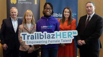 Image for Women holds a phone in her hand and looks out to her left.