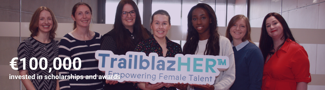 A group of women pose with a TrailblazHER sign