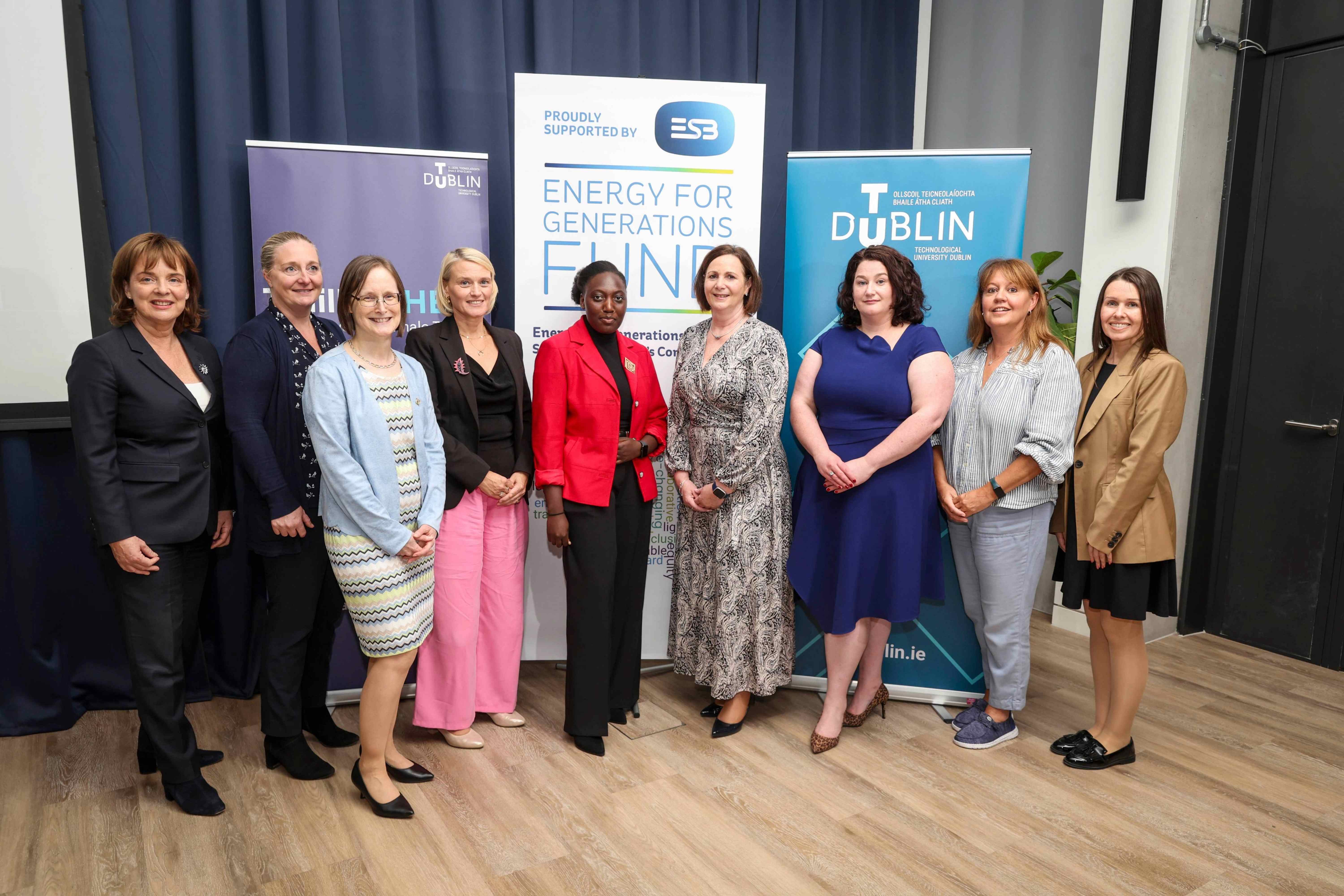 Group photograph celebrating the 2026 ESB TrailblazHER Scholarship at ESB Headquarters in Dublin. Scholarship recipient Ericah Ncube stands at the centre wearing a red blazer, surrounded by eight female representatives from TU Dublin and ESB. TrailblazHER, TU Dublin and ESB banners are displayed in the background.