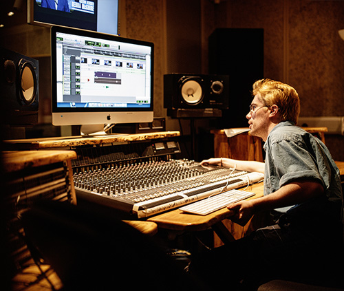 Student working at a mixing desk