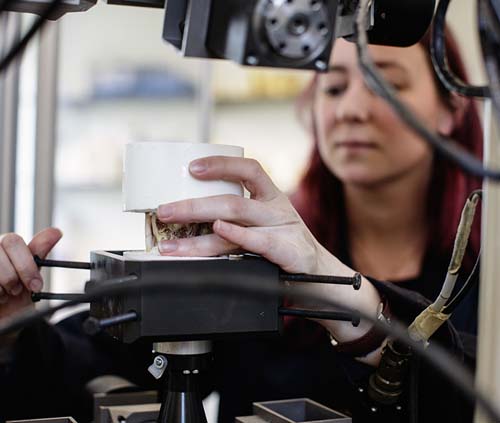 Student working on a piece with a machine