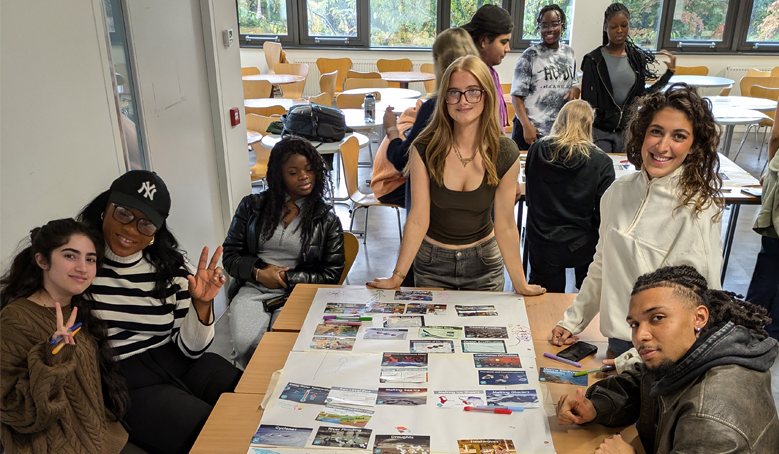 Image for students around a desk at a workshop