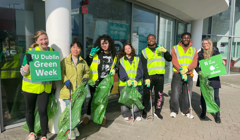 Image for cartoon people sitting at desks holding signs with environmental icons