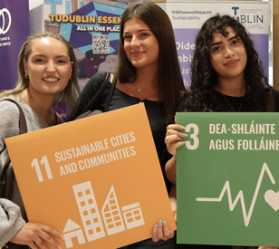 female students hold sdg signs