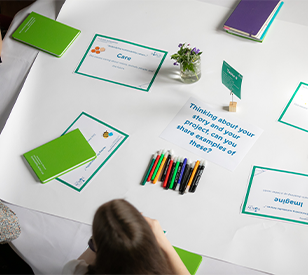 Person sitting at table with notes about how to tell your story