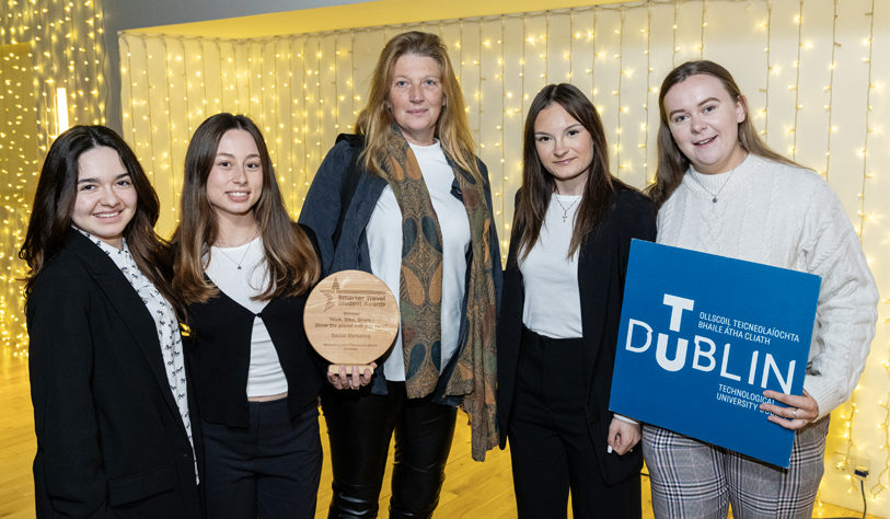 Four young white women with their tutor receiving a student travel award