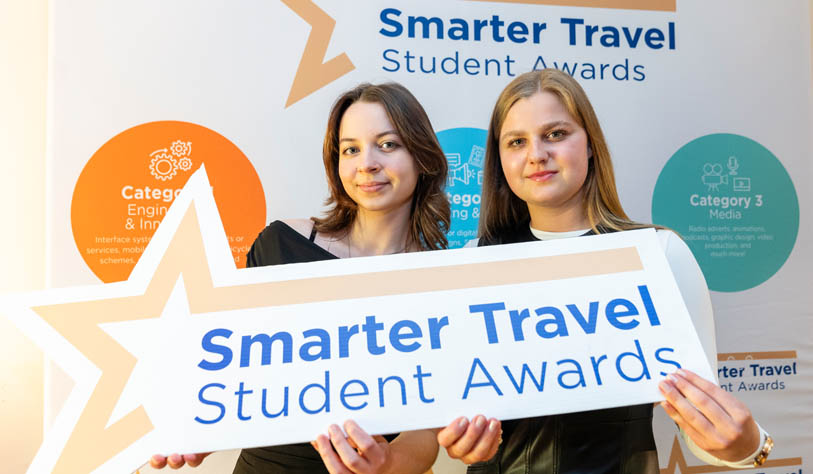 Two white young women receiving Student Travel Award