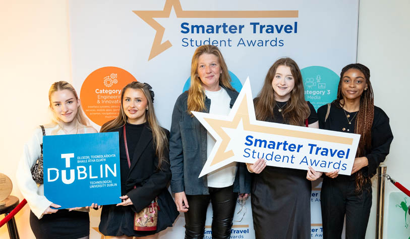 three white young women and one young black women with their tutor receiving Student Travel Award