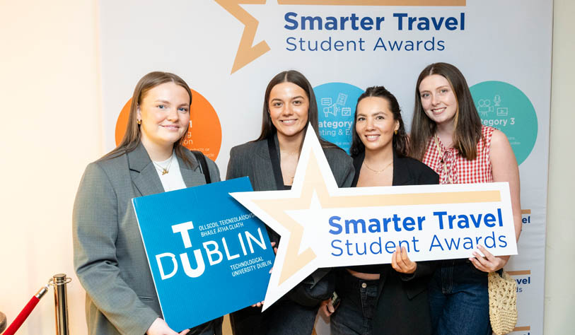 three white young women and one Asian woman receiving Student Travel Award