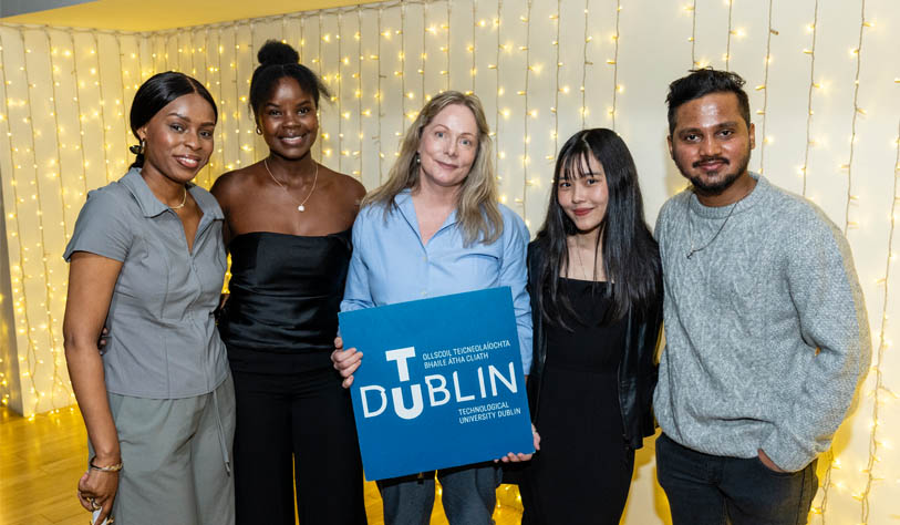 Two young black women, a white woman, a young Asian woman and a young Asian mad pictured receiving a student award