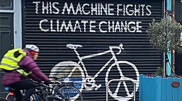 Image for This machine fights climate change spray painted on shop front shutters
