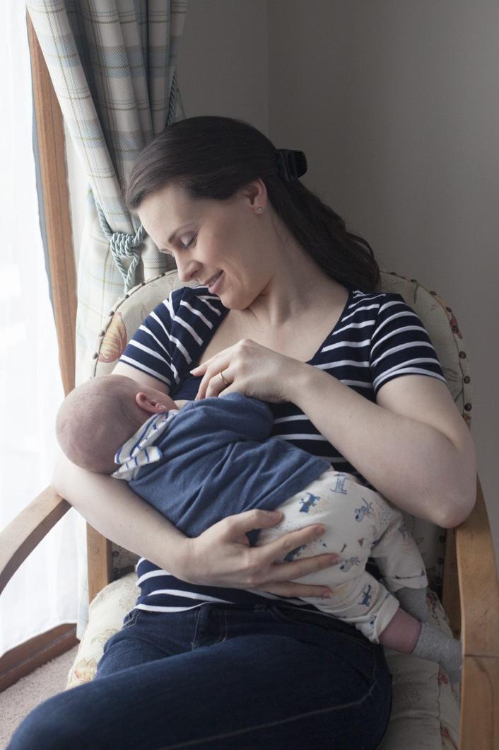 A woman breastfeeding her baby