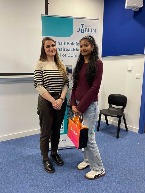 Person receiving prize from another individual