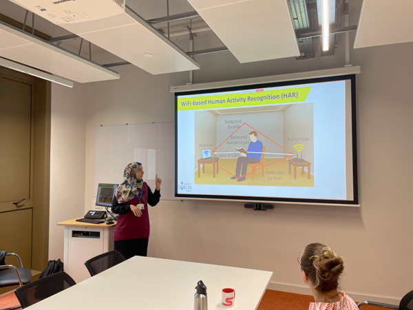 person pointing at slides on a screen
