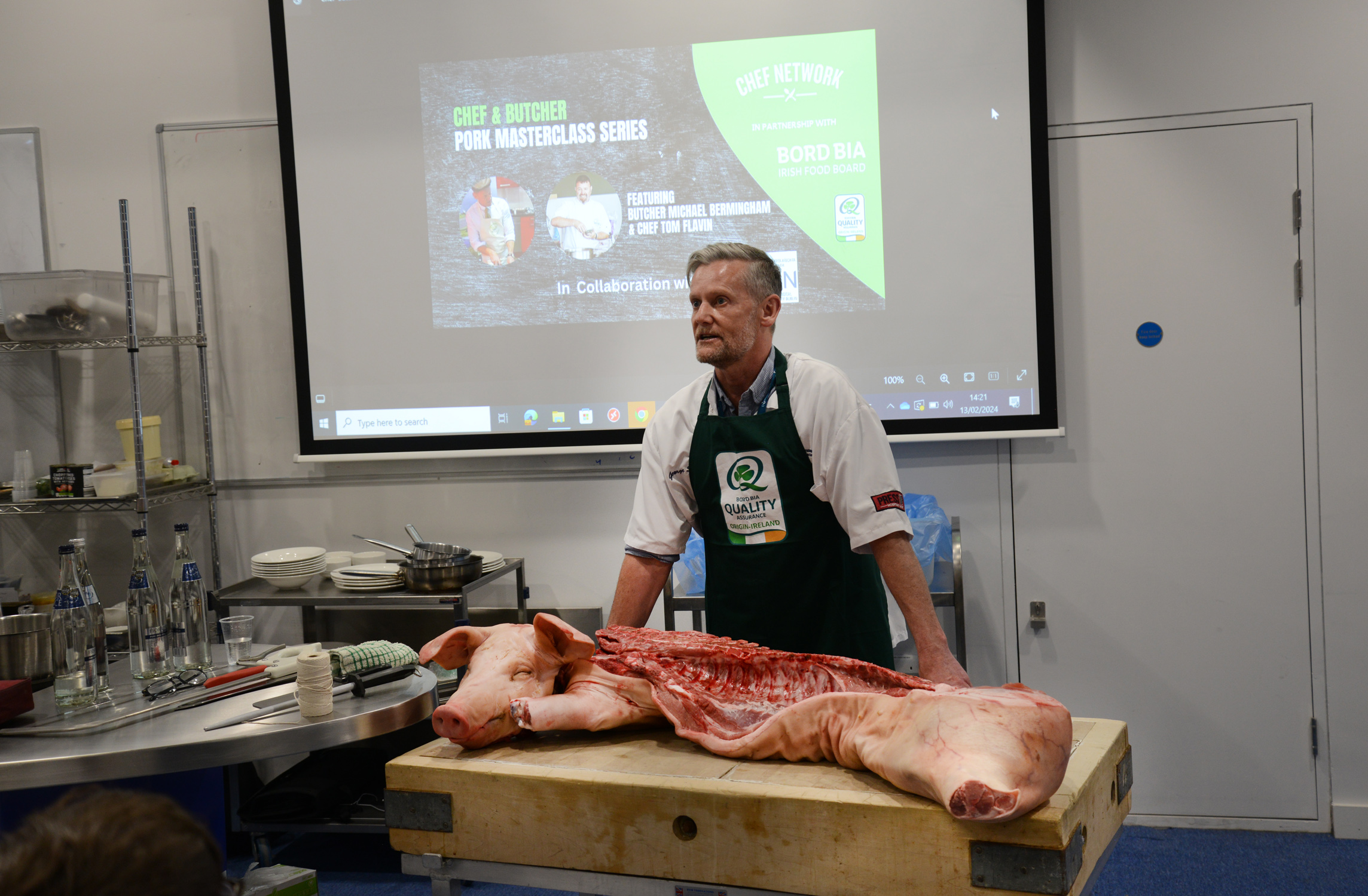 Butcher Michael Bermingham demonstrating different cuts of Pork