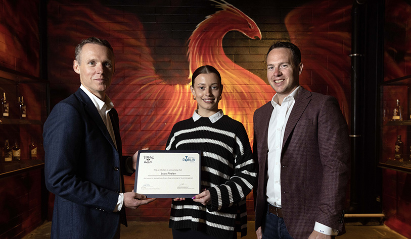 Photo of student receiving her Scholarship certificate from Teeling staff.