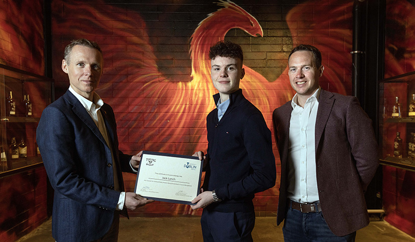 Photo of student receiving his Scholarship certificate from Teeling staff.