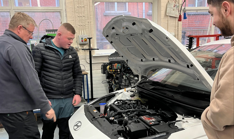 Student looking at engine
