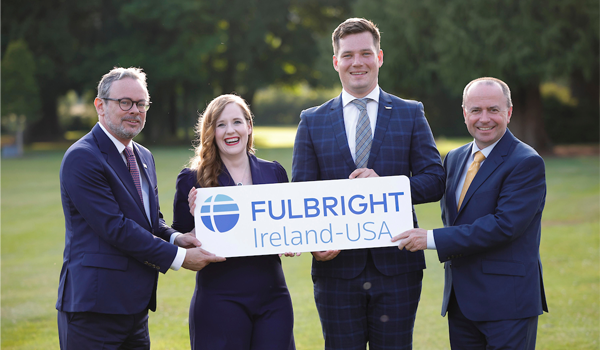 Group of four people celebrating award