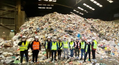 students with recyclable waste