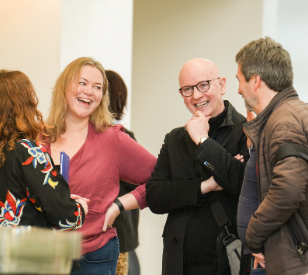 A group of 4 event participants chatting