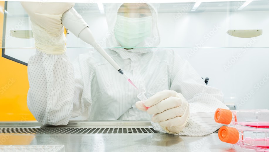 Person in lab using pipette