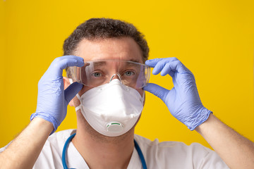 man with safety glasses, gloves and mask on