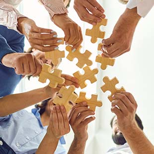 Hands holding jigsaw pieces