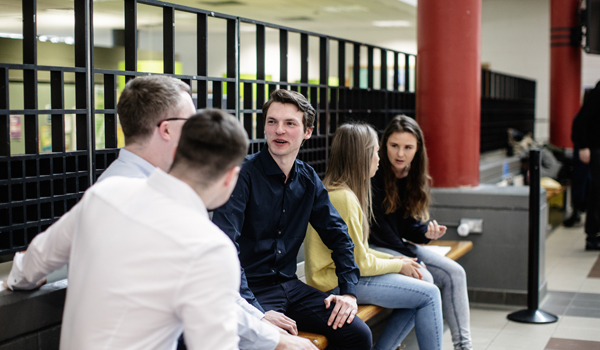 Students chatting sitting on a bench