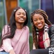 Two students sitting outside on campus