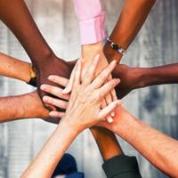 People putting hands together to show teamwork