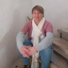 image of Christina Malone, chaplain, sitting on stairs