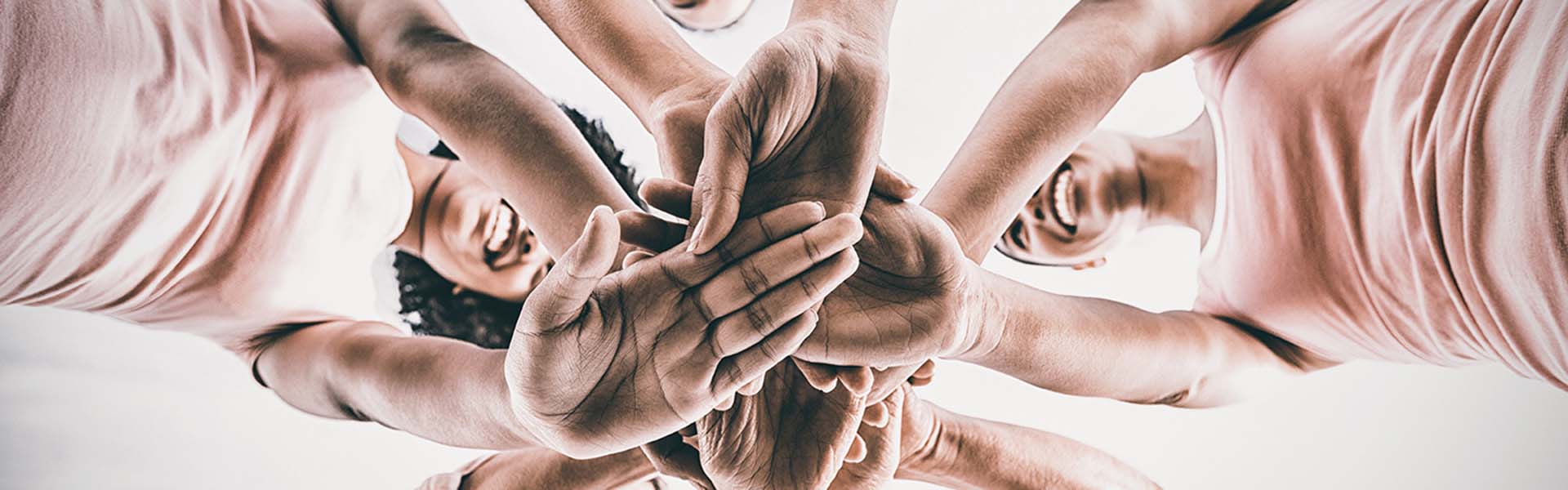 people joining hands together