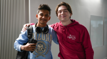 Two TUD Students with arms around shoulder