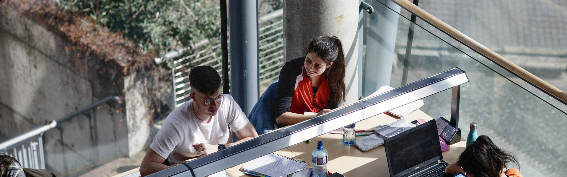 Students studying at desk beside window in the blanchardstown library at TUDublin
