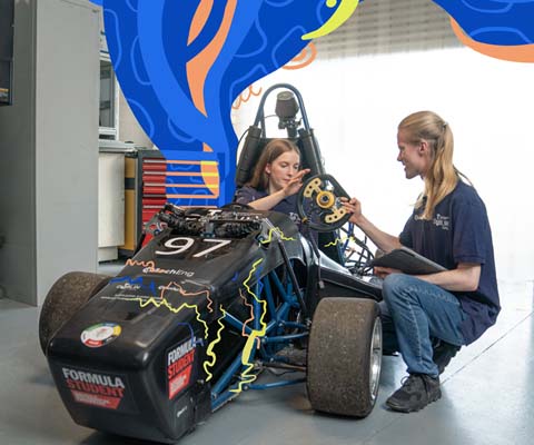 mechanical engineering students working on formula one car