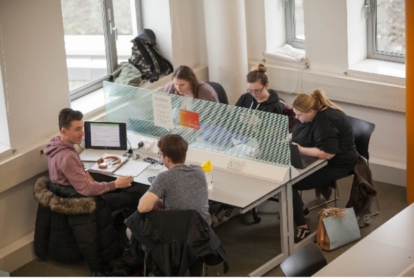 Students interacting in the library study space.